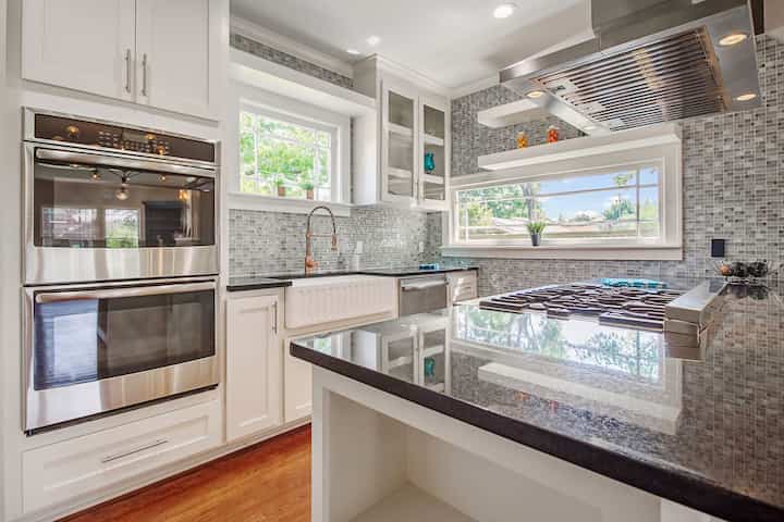 An image of a modern kitchen with sleek appliances, featuring a gas stove, refrigerator, and built-in microwave in Naperville